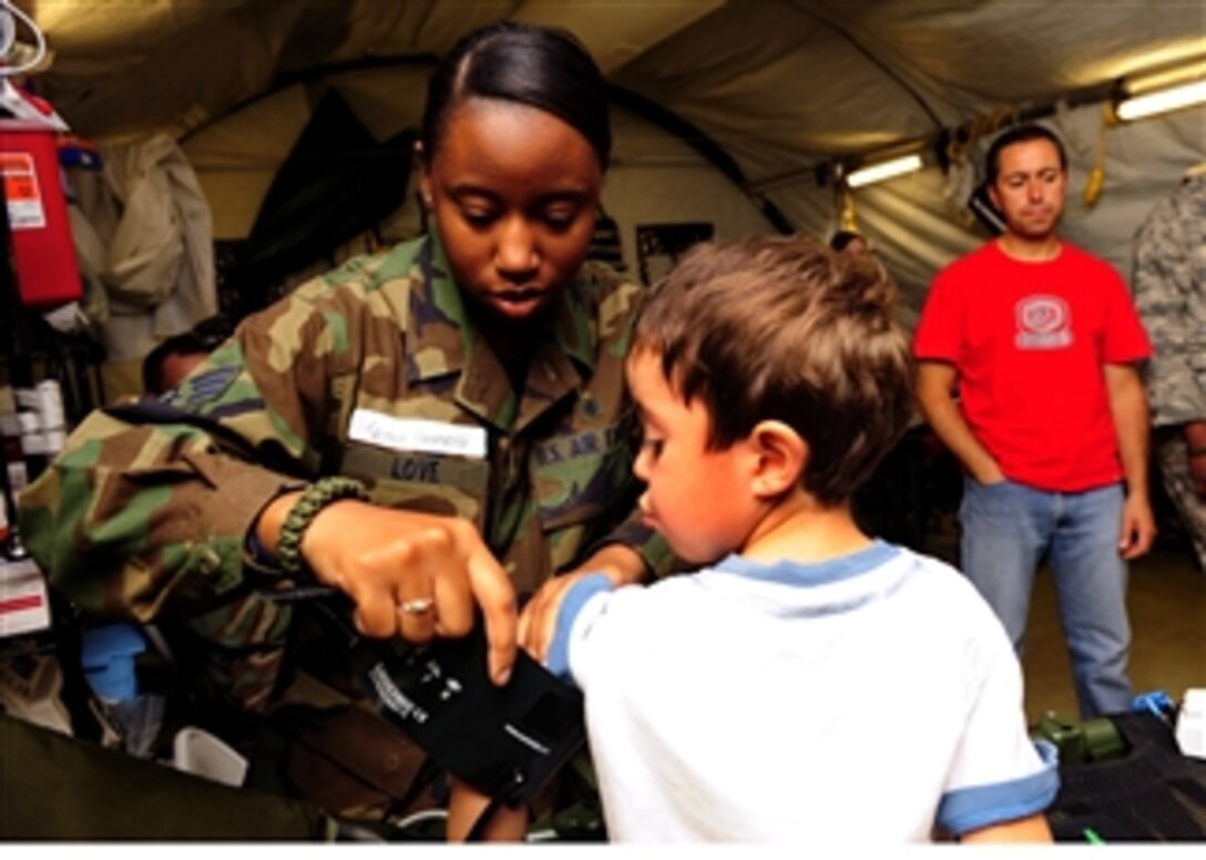 Senior Airman Kahliha Love checks the vital signs of a Chilean child at the expeditionary hospital in Angol, Chile, on March 20, 2010.  About 60 medical airmen are working alongside local Chilean medics to provide support to meet the daily medical needs of the 110,000 people in the region.  The local hospital in Angol was deemed structurally unsound after an 8.8-magnitude earthquake on Feb. 27, 2010.  Love is an aerospace medical technician assigned to the 81st Medical Operating Squadron at Keesler Air Force Base, Miss.  