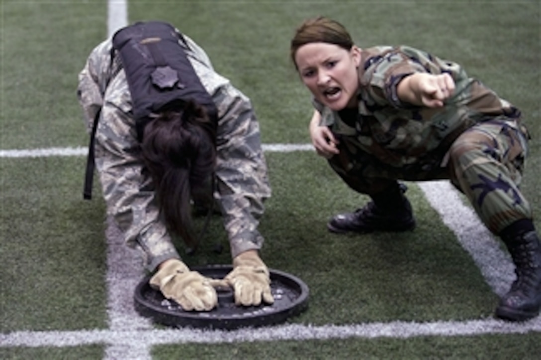 U.S. Air Force Academy Cadet 1st Class Morgan Trevarthen motivates a fourth class cadet during Recognition events at the academy in Colorado on March 12, 2010.  Recognition, which consists of several days of activities that are designed to mentally and physically challenge freshmen cadets, culminates with the ascension of the freshmen into the ranks of upper-classmen.  