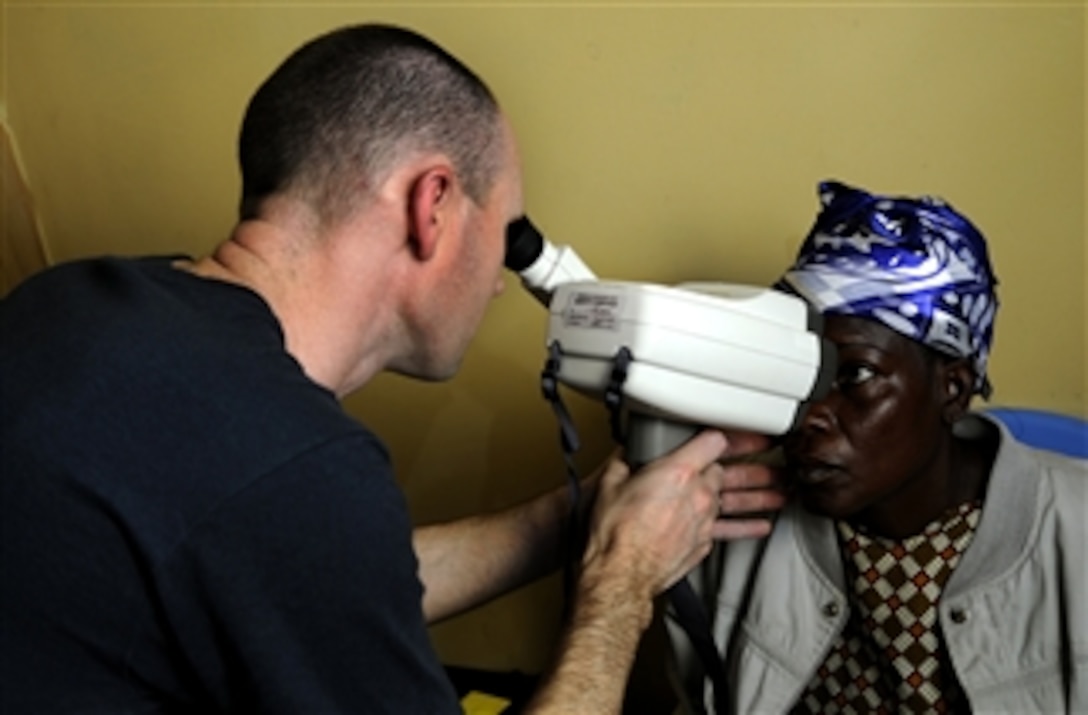 U.S. Navy Lt. Cmdr. Mike Sunman conducts an eye examination on a Ghanaian woman during a medical outreach program at Manhean Health Center in Tema, Ghana, as part of Africa Partnership Station West on March 17, 2010.  Africa Partnership Station West is an international initiative developed by U.S. Naval Forces Europe/Africa that improves maritime safety and security on the continent of Africa.  