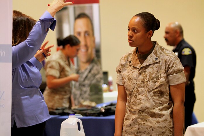Sgt. Deborah Scott, fiscal clerk, Reserve Support Unit, Marine Corps Base Camp Pendleton, listens to a representative from one of the 130 organizations represented at the Marine Corps Community Services 2010 Spring Career and Education Expo held at Camp Pendleton’s South Mesa Club, March 25. The event was mainly geared toward military members who are transitioning out the service and family members looking to kick start or change careers.