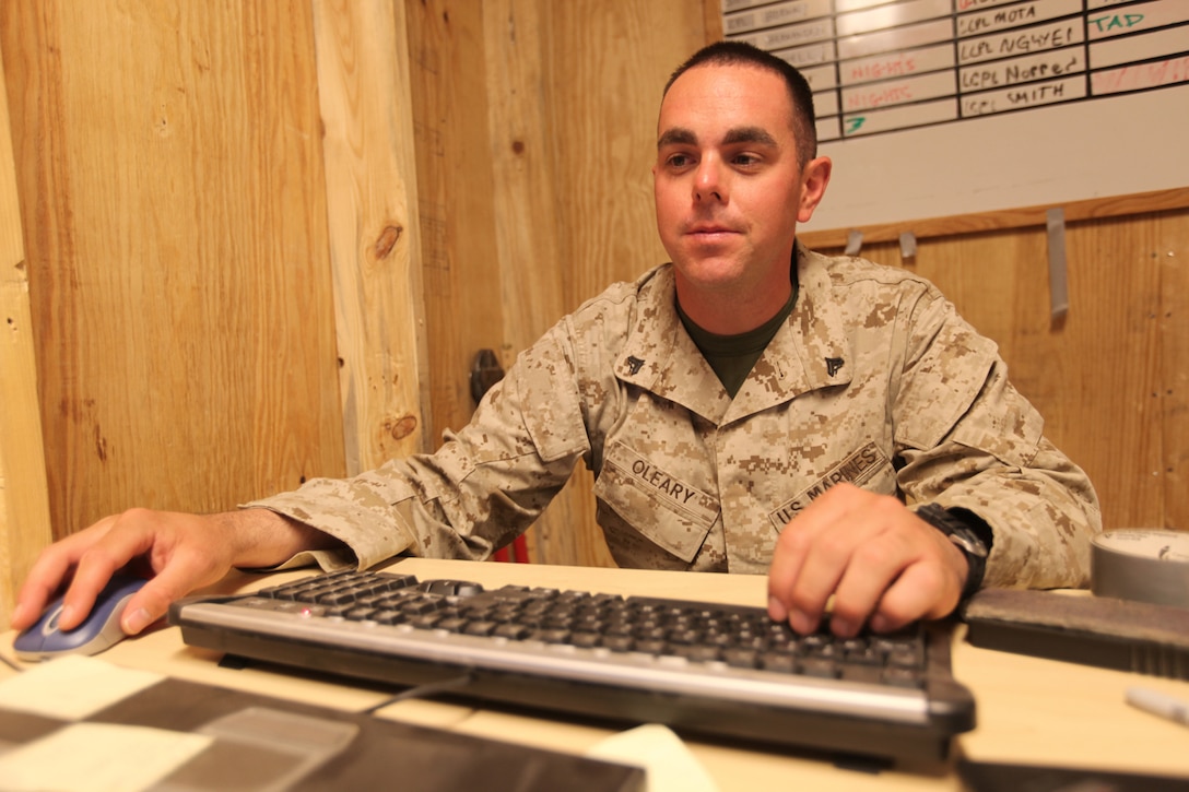 Cpl. Ryan F. O'Leary, data network specialist for G-6, Combat Logistics Regiment 17, 1st Marine Logistics Group (Forward), fixes the network for Marines in the unit at Camp Leatherneck, Afghanistan, March 27. O'Leary, 28, from Sayville, N.Y., works as a police officer for the New York Police Department during his time as a Marine reservist for the 6th Communications Battalion of Brooklyn, N.Y.