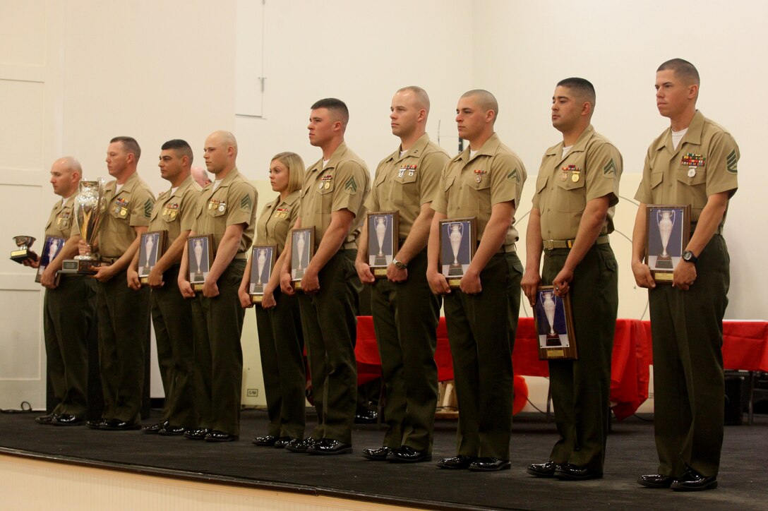 Members of the Marine Corps Shooting Team stand after receiving the Inter-Corps Cup and Royal Marines Bowl for winning a shooting match against the British Royal Marines Shooting Team during the Competition In Arms Program Eastern Division Match award ceremony, March 26. The eastern division match is the second in the CIAP’s three-part Marine Corps-wide marksmanship competition.