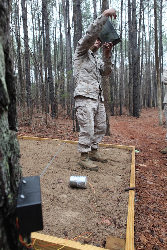 A Marine with 26th Marine Expeditionary Unit takes a closer look at a mock improvised explosive device during IED awareness training at Fort Pickett, Va., March 26, 2010. 26th MEU, which consists of Battalion Landing Team 3/8, Combat Logistics Battalion 26, and Marine Medium Tiltrotor Squadron 266, will spend the next six months training for their upcoming deployment. (Official United States Marine Corps Photo by Lance Cpl.  Santiago G. Colon Jr.) (Released)::r::::n::
