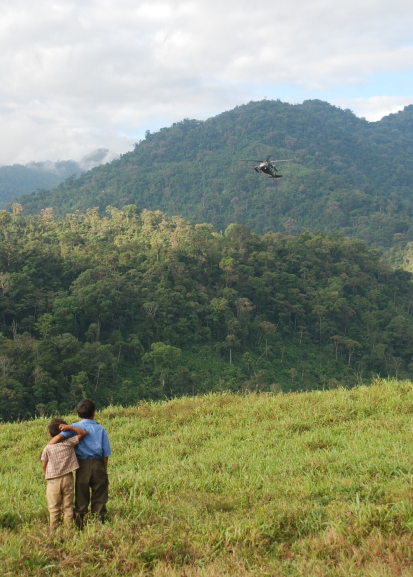 Costa Rican boys watch as a U.S. Army HH-60 Blackhawk lands in Piedra Meza, Costa Rica, March 25. Three helicopters (1 CH-47 Chinook and 2 HH-60 Blackhawks) from the 228th Aviation Regiment provided airlift for a medical civic assistance program, or MEDCAP, conducted in the mountaintop village March 24-26 by a team of Joint Task Force-Bravo and Costa Rican medical providers. (U.S. Air Force photo by 1st Lt. Jen Richard)