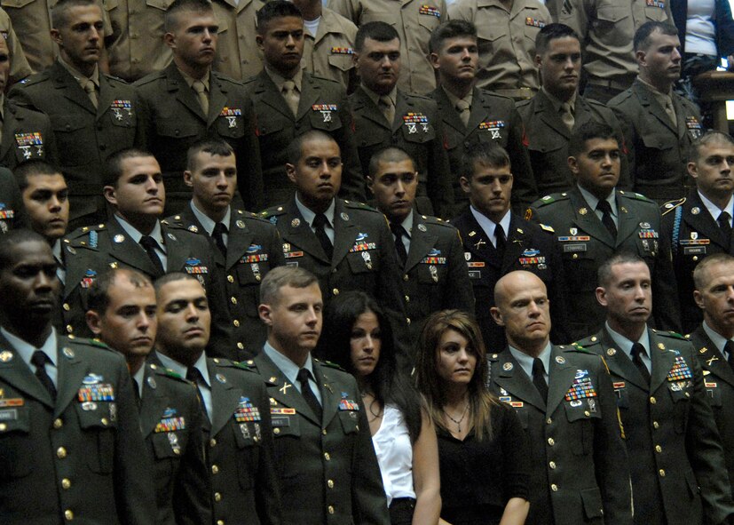 U. S. Army soldiers, Marines Corps, and family members, stand during a special ceremony honoring 28 fallen service members being presented the Hawaii Medal of Honor posthumously, at the State Capitol, Honolulu, Hawaii, March 23, 2010.  The Hawaii Medal of Honor was created in 2005 to recognize the heroism of those members of the U.S. armed forces with links to Hawaii who are killed in action while serving our country as part of Operation Iraqi Freedom and Operation Enduring Freedom in Iraq and Afghanistan. The presentation of the Hawaii Medal of Honor was the first of its kind in the nation, and has become the model for similar ceremonies in other states. (U.S. Air Force photo/Tech. Sgt. Jerome S. Tayborn)