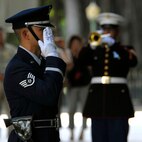 A member of Joint Base Hickam Pearl Harbor?s honor guard salutes a 21-Gun Salute and the playing of Taps by a U.S. Marine Corps bandsman, to honor 28 fallen service members being presented the Hawaii Medal of Honor posthumously, during a special ceremony at the State Capitol, Honolulu, Hawaii, March 23, 2010.  The Hawaii Medal of Honor was created in 2005 to recognize the heroism of those members of the U.S. armed forces with links to Hawaii who are killed in action while serving our country as part of Operation Iraqi Freedom and Operation Enduring Freedom in Iraq and Afghanistan. The presentation of the Hawaii Medal of Honor was the first of its kind in the nation, and has become the model for similar ceremonies in other states. (U.S. Air Force photo/Tech. Sgt. Jerome S. Tayborn)
