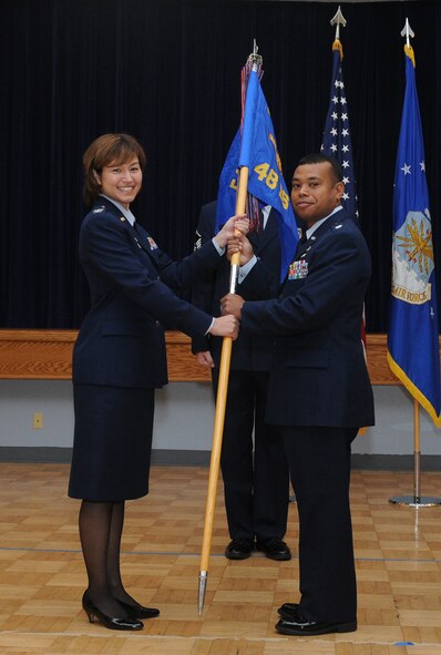 Lt. Col. James Lawrence, incoming 48th Intelligence Squadron commander, receives the guide-on from Colonel Jenny McGee, 548th Intelligence Surveillance and Reconnaissance Group commander, March 26 at the Community Activities Center. Col. Lawrence’s previous assignment was as the Operations Assignment Branch, Air Force Personnel Center, Randolph Air Force Base, Texas. (Air Force Photo by Staff Sgt. Aaron C. Oelrich)