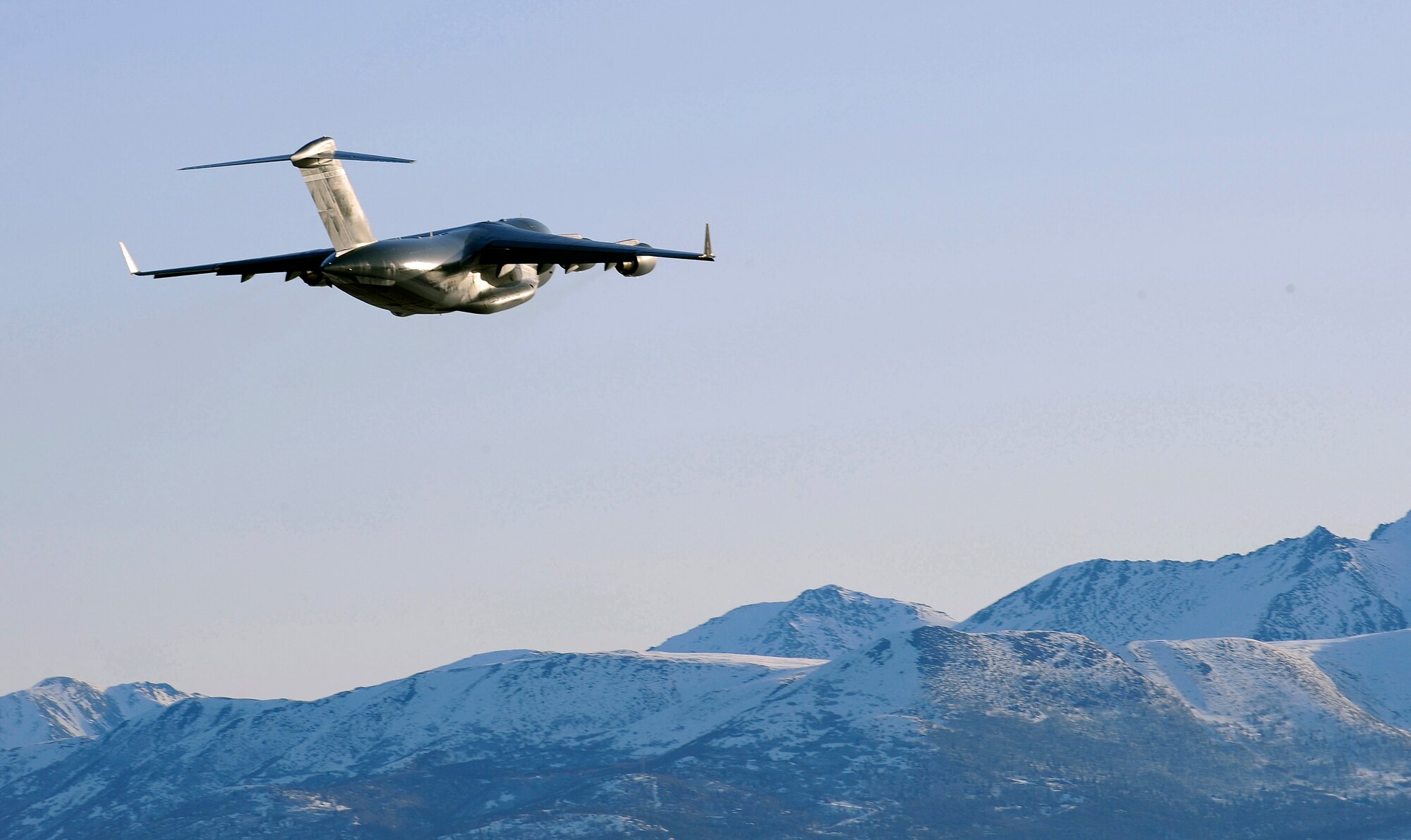 A C-17 Globemaster III takes off from Elmendorf Air Force Base March 26.  Col. Thomas Bergeson, 3rd Wing commander and F-22 Raptor pilot, was behind the controls of the aircraft for the first time. The flight included a KC-135 Stratotanker refuel, tactical arrivals and departures at Allen Army Airfield and low-level flying.  (U.S. Air Force photo/Staff. Sgt. Brian Ferguson)