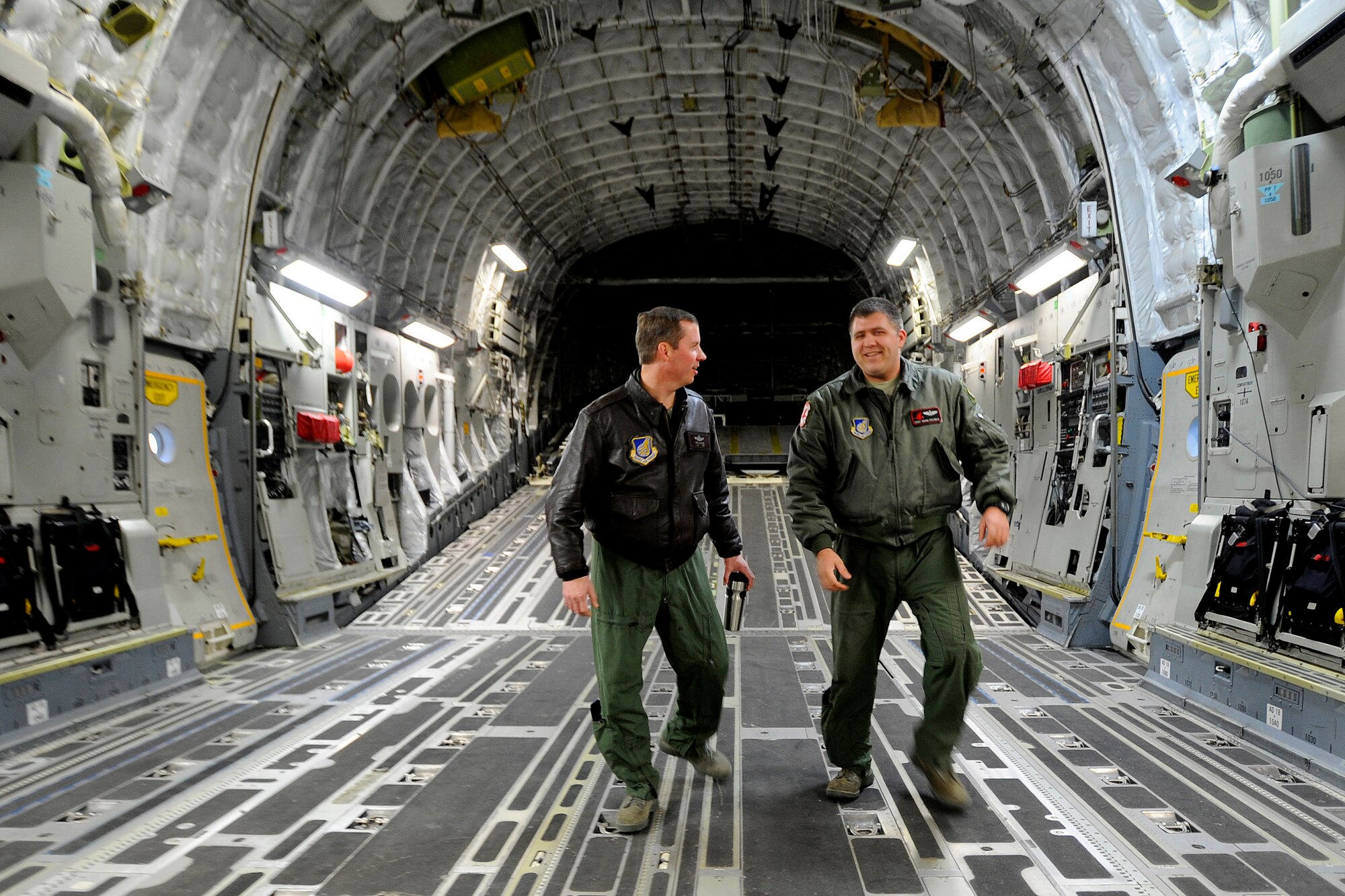 Staff Sgt. Adam Koerner explains the egress procedures of a C-17 Globemaster III to Col. Thomas Bergeson before a flight at Elmendorf Air Force Base, March 26. Colonel Bergeson, 3rd Wing commander and F-22 Raptor pilot, took the controls of the aircraft for the first time. The flight included a KC-135 Stratotanker refuel, tactical arrivals and departures at Allen Army Airfield and low-level flying.  Sergeant Koerner is a loadmaster assigned to the 517th Airlift Squadron here.  (U.S. Air Force photo/Staff. Sgt. Brian Ferguson)