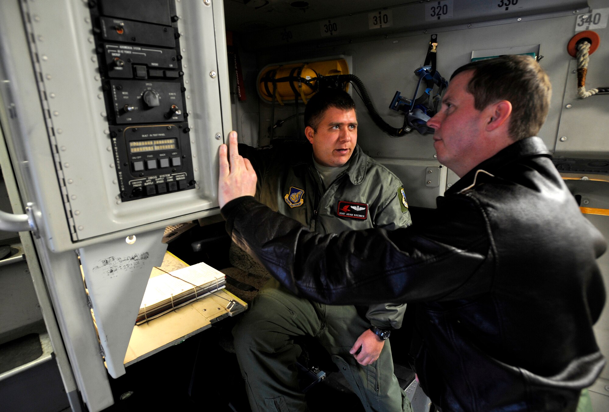 Staff Sgt. Adam Koerner explains the egress procedures of a C-17 Globemaster III to Col. Thomas Bergeson before a flight at Elmendorf Air Force Base, March 26. Colonel Bergeson, 3rd Wing commander and F-22 Raptor pilot, took the controls of the aircraft for the first time. The flight included a KC-135 Stratotanker refuel, tactical arrivals and departures at Allen Army Airfield and low-level flying.  Sergeant Koerner is a loadmaster assigned to the 517th Airlift Squadron here.  (U.S. Air Force photo/Staff. Sgt. Brian Ferguson)