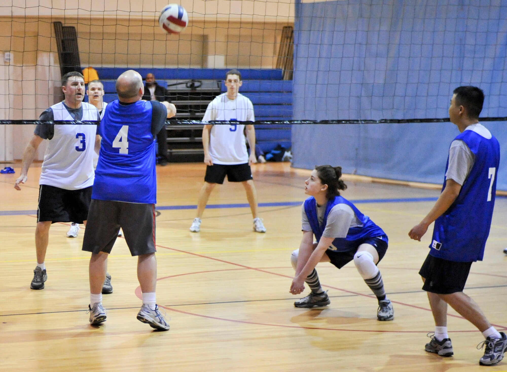 ELMENDORF AIR FORCE BASE, Alaska – Douglas Hoffmaster, 4, and Jenifer Paden of the 3rd Cilvil Engineer Squadron work together in attempt to get the ball over the net during a game of intramural volleyball, March 24, against the 3rd Communications Squadron. The first set played between the two teams was close with the 3rd CS winning 25-23. However, the second game wasn’t as close with the 3rd CS clobbering the 3rd CES with the score of 25-13, to win the game. (Air Force photo by Airman 1st Class Christopher Gross)