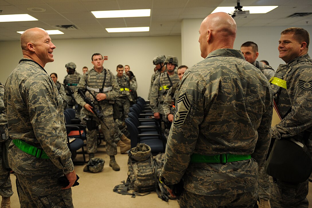 LANGLEY AIR FORCE BASE, Va. --Lt. Col. William Brooks, 633d Security Forces Squadron, and Chief Master Sgt. Tim Murphy, 633d SFS functional manager, speak with security forces Airmen as they prepare to process the personnel deployment function line during a Phase I Operational Readiness Exercise here March 26. Wing Exercise Evaluation Team members will spend two days assessing the ability of the 633d Air Base Wing, 1st Fighter Wing, and 192d Fighter Wing to deploy cargo, aircraft and Airmen within a limited timeframe. (U.S. Air Force photo/Airman Rebecca Montez)