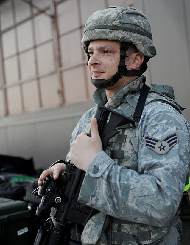LANGLEY AIR FORCE BASE, Va. -- Senior Airman Paul Miller, 633d Security Forces Squadron, awaits transportation after completing the personnel deployment function line during a Phase I Operational Readiness Exercise here March 26. Wing Exercise Evaluation Team members will spend two days assessing the ability of the 633d Air Base Wing, 1st Fighter Wing, and 192d Fighter Wing to deploy cargo, aircraft and Airmen within a limited timeframe. (U.S. Air Force photo/Airman Rebecca Montez)