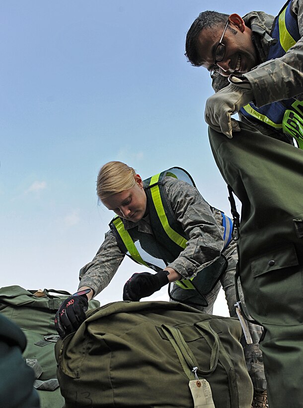 LANGLEY AIR FORCE BASE, Va. -- 2nd Lt. Kady Rohan and Senior Airman Wilbur Raguini, 633d Civil Engineer Squadron, inspect bags for hazardous materials during a Phase I Operational Readiness Exercise here March 26. Wing Exercise Evaluation Team members will spend two days assessing the ability of the 633d Air Base Wing, 1st Fighter Wing, and 192d Fighter Wing to deploy cargo, aircraft and Airmen within a limited timeframe. (U.S. Air Force photo/Airman Rebecca Montez)

