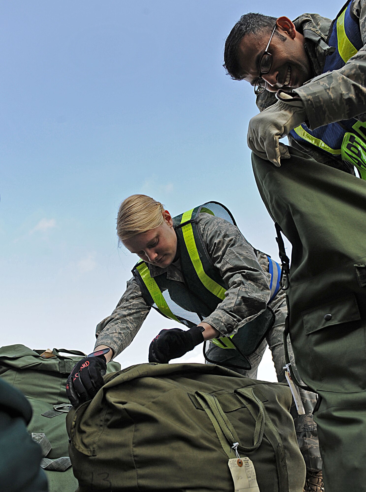 LANGLEY AIR FORCE BASE, Va. -- 2nd Lt. Kady Rohan and Senior Airman Wilbur Raguini, 633d Civil Engineer Squadron, inspect bags for hazardous materials during a Phase I Operational Readiness Exercise here March 26. Wing Exercise Evaluation Team members will spend two days assessing the ability of the 633d Air Base Wing, 1st Fighter Wing, and 192d Fighter Wing to deploy cargo, aircraft and Airmen within a limited timeframe. (U.S. Air Force photo/Airman Rebecca Montez)
