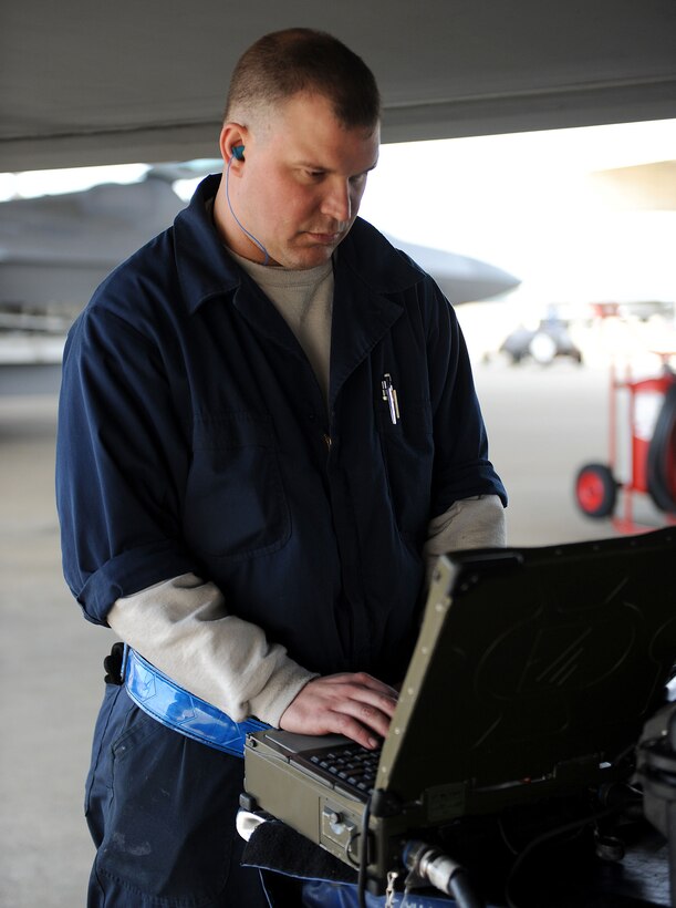 LANGLEY AIR FORCE BASE, Va. -- Tech. Sgt. Russell Fontaine, 1st Aircraft Maintenance Unit, checks the status of an F-22 on a portable maintenance aid during a Phase I Operational Readiness Exercise March 25. This ORE generated more raptors than any previous Phase I ORE at Langley. (U.S. Air Force photo/Airman Rebecca Montez)