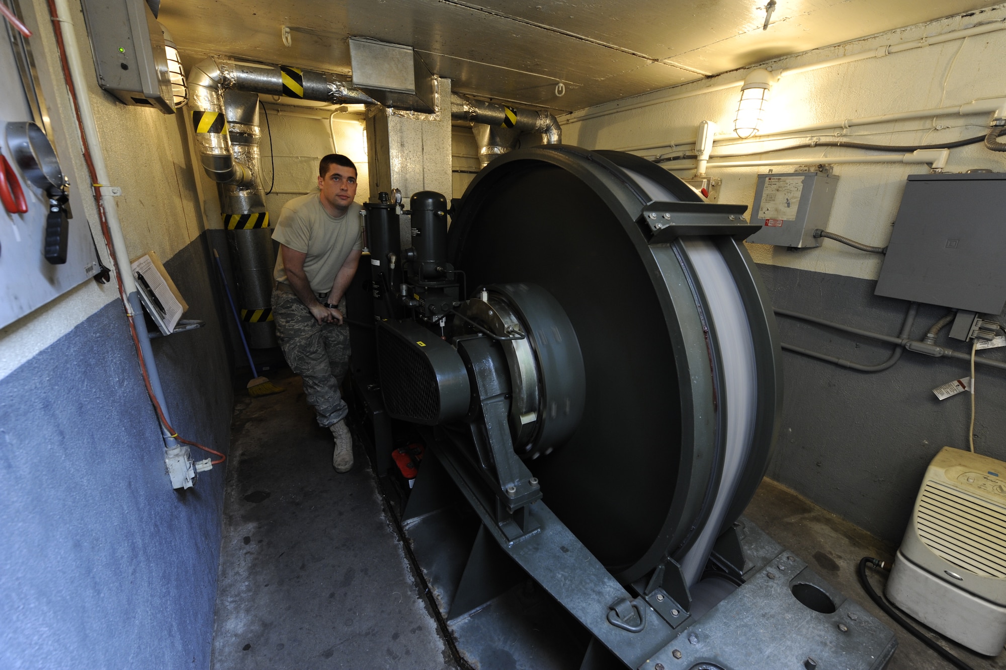 U.S. Air Force Staff Sgt. Albert Sonnenberg operates a rewind clutch to bring the nylon arrest tape back into the barrier maintenance pit at Joint Base Charleston, S.C., March 25, 2010. The tape is designed to help stop aircraft equipped with an arresting hook while landing. Sergeant Sonnenberg is a barrier maintenance technician with the 628th Civil Engineer Squadron. (U.S. Air Force photo by James M. Bowman/released)