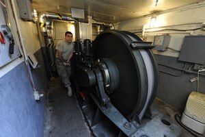 U.S. Air Force Staff Sgt. Albert Sonnenberg operates a rewind clutch to bring the nylon arrest tape back into the barrier maintenance pit at Joint Base Charleston, S.C., March 25, 2010. The tape is designed to help stop aircraft equipped with an arresting hook while landing. Sergeant Sonnenberg is a barrier maintenance technician with the 628th Civil Engineer Squadron. (U.S. Air Force photo by James M. Bowman/released)