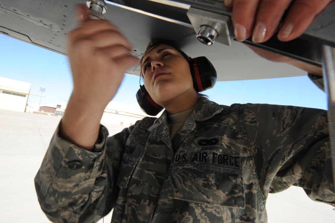 ELLSWORTH AIR FORCE BASE, S.D.-Airman 1st Class Erin Johnson, 28th Maintenance Squadron aircraft fuels system apprentice, uses a Johnson bar to remove screws from a B-1B Lancer dump panel, March 25. Airman Johnson removed the dump panel to access necessary parts. (U.S. Air Force photo/Senior Airman Adam Grant)    