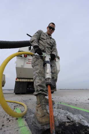 U.S. Air Force Airman 1st Class Jerry Cook uses a jack hammer to break up defective pavement on the runway so it can be removed and replaced with asphalt at Joint Base Charleston, S.C., March, 25, 2010. Base civil engineers have monthly runway closures to repair discrepancies as well as on an as-need basis. Airman Cook is a pavements and equipment journeyman with the 628th Civil Engineer Squadron. (U.S. Air Force photo by James M. Bowman/released)