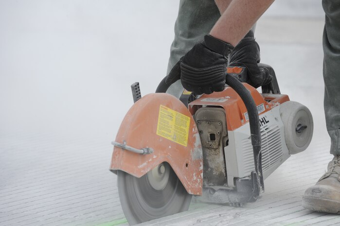 U.S. Air Force Staff Sgt. Kyle Hiener cuts defective pavement on the runway so it can be jack hammered and replaced with asphalt at Joint Base Charleston, S.C., March 25, 2010. Base civil engineers perform monthly runway closures to repair discrepancies as well as on an as-need basis. Sergeant Hiener is a pavements and equipment technician with the 628th Civil Engineer Squadron. (U.S. Air Force photo by James M. Bowman/released)