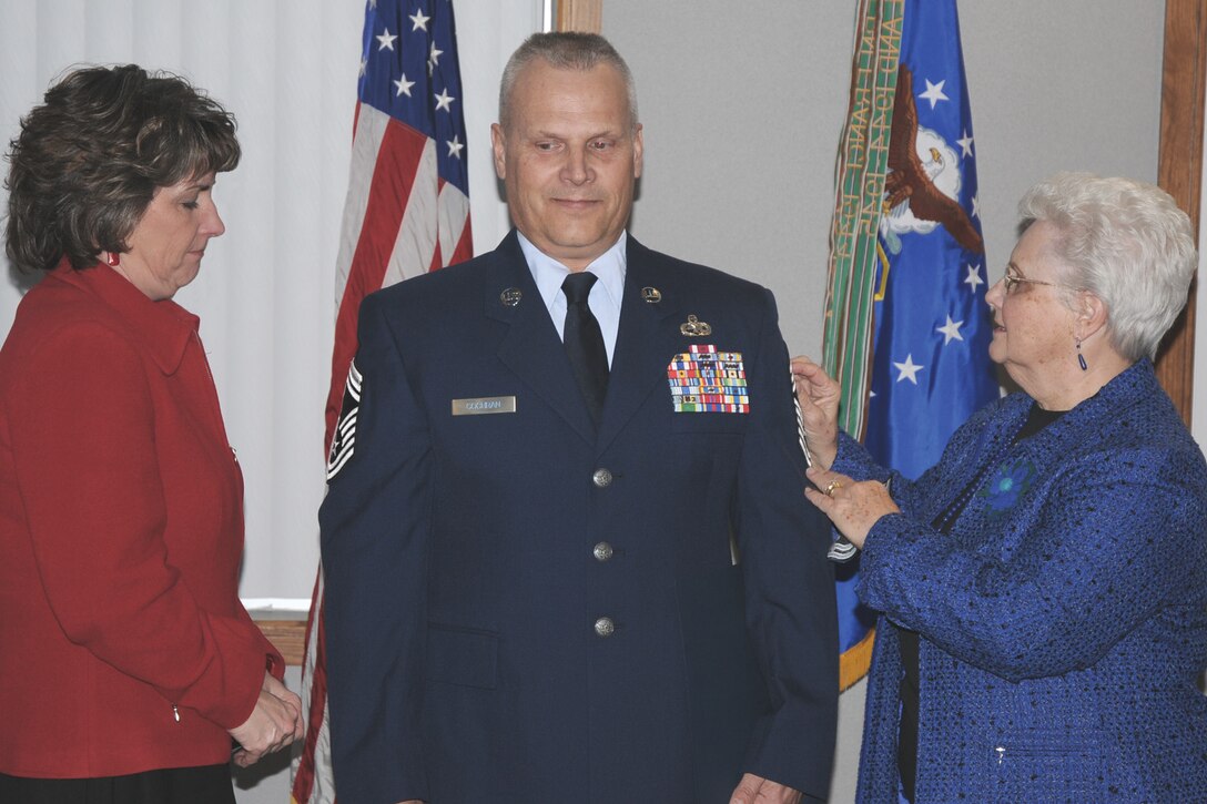 During a pining ceremony held February 19, 2010, at the 132nd Fighter Wing, Des Moines, Iowa, newly promoted Chief Master Sgt. Tim Cochran?s wife Teresa and mother Rosalie unveil his Chief Master Sgt. chevrons. Chief Cochran assumes the position of Superintendent of the 132nd Maintenance Operations Flight. (U.S. Air Force photo/Senior Master Sgt. Tim Day)(released)