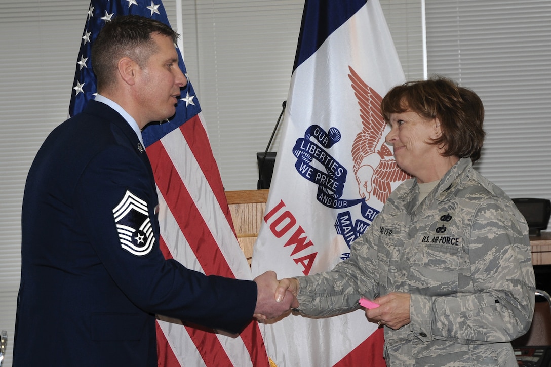 132nd Mission Support Commander Col. Jennifer Walter (right) congratulates newly pinned Chief Master Sgt. Mark Louw (left) at his pinning ceremony held at the 132d Fighter Wing, Des Moines, Iowa on January 23, 2010.  Chief Louw will be working as the Logistics Readiness Squadron Chief of Supply.  (U.S. Air Force photo/Staff Sgt. Linda E. Kephart)(Released)