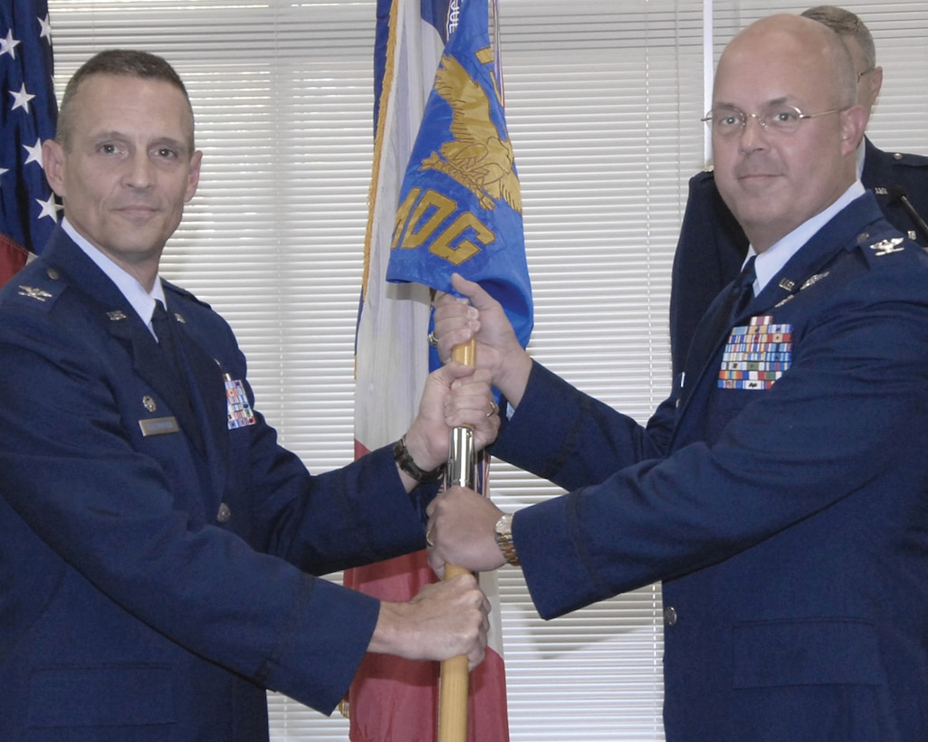 Col. James H. Bartlett (right) receives the 132nd  Medical Group guidon from Col. Randy E. Greenwood,132nd Maintenance Group Commander, (left) during a change of command ceremony held Sept. 12, 2009, at the 132nd Fighter Wing?s DFAC, Des Moines, Iowa. Col. Bartlett returns to the position after a five year tour as State Air Surgeon with Iowa JFHQ. (U.S. Air Force photo/ Staff Sgt. Linda Kephart)