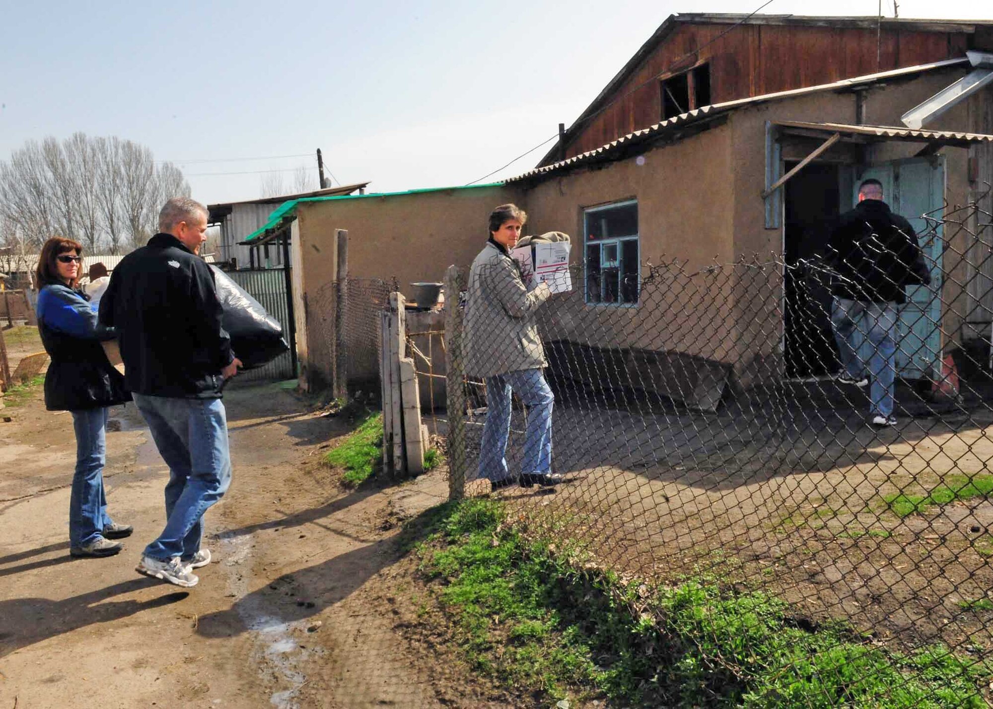 People from the Transit Center at Manas, Kyrgyzstan, unload humanitarian assistance items collected from stateside bases and friends to distribute to families March 18, 2010, in Manas Village. (U.S. Air Force photo/Staff Sgt. Carolyn Viss)