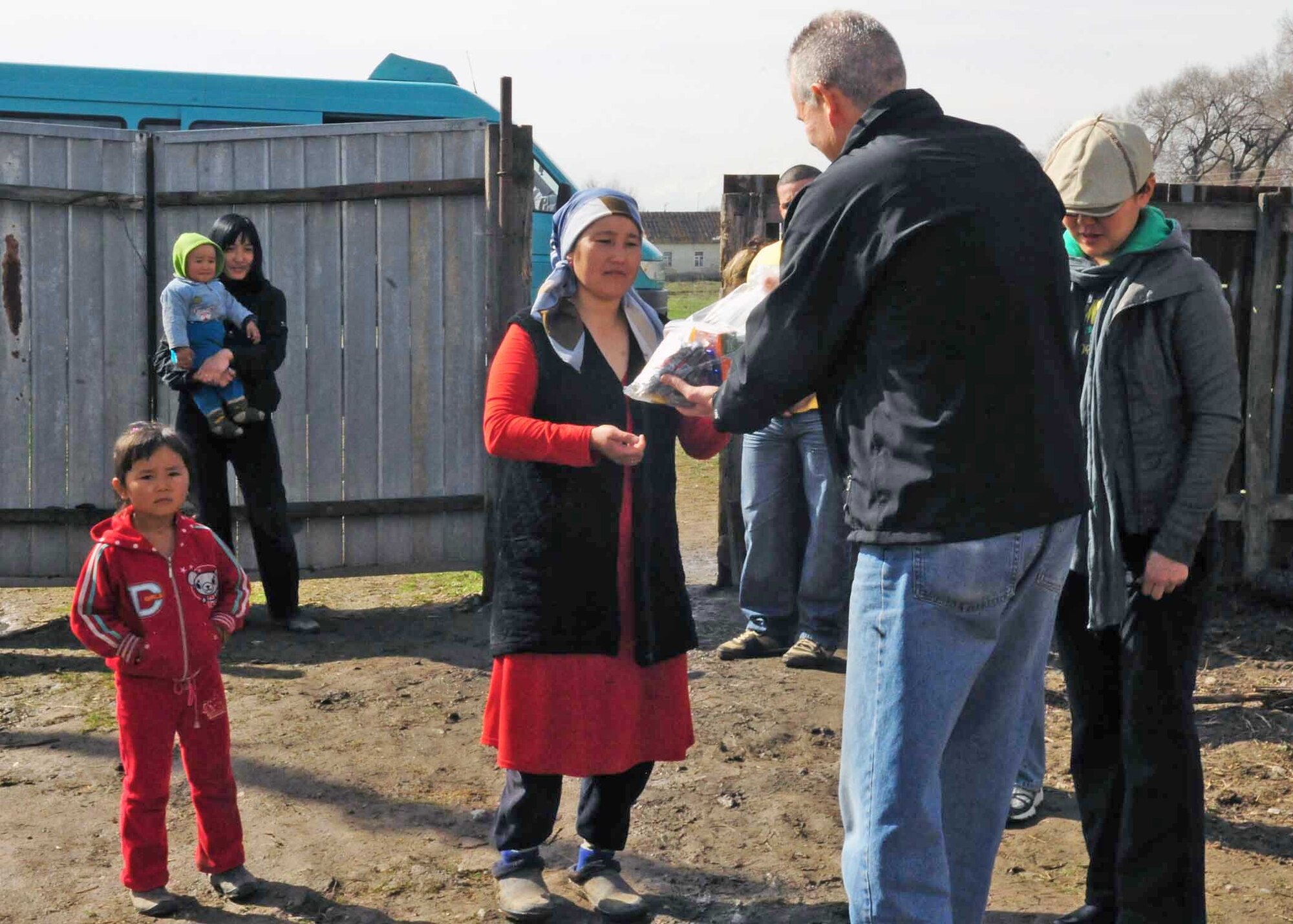 Lt. Col. Rex Vanderwood delivers humanitarian assistance items collected from stateside bases and friends to a family March 18, 2010, in Manas Village, Kyrgyzstan. Colonel Vanderwood is the 376th Expeditionary Mission Support Group deputy commander. (U.S. Air Force photo/Staff Sgt. Carolyn Viss)