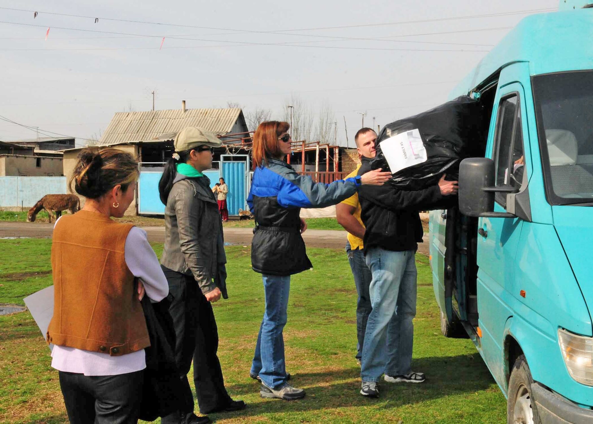 People from the Transit Center at Manas, Kyrgyzstan, unload humanitarian assistance items collected from stateside bases and friends to distribute to families March 18, 2010, in Manas Village. (U.S. Air Force photo/Staff Sgt. Carolyn Viss)