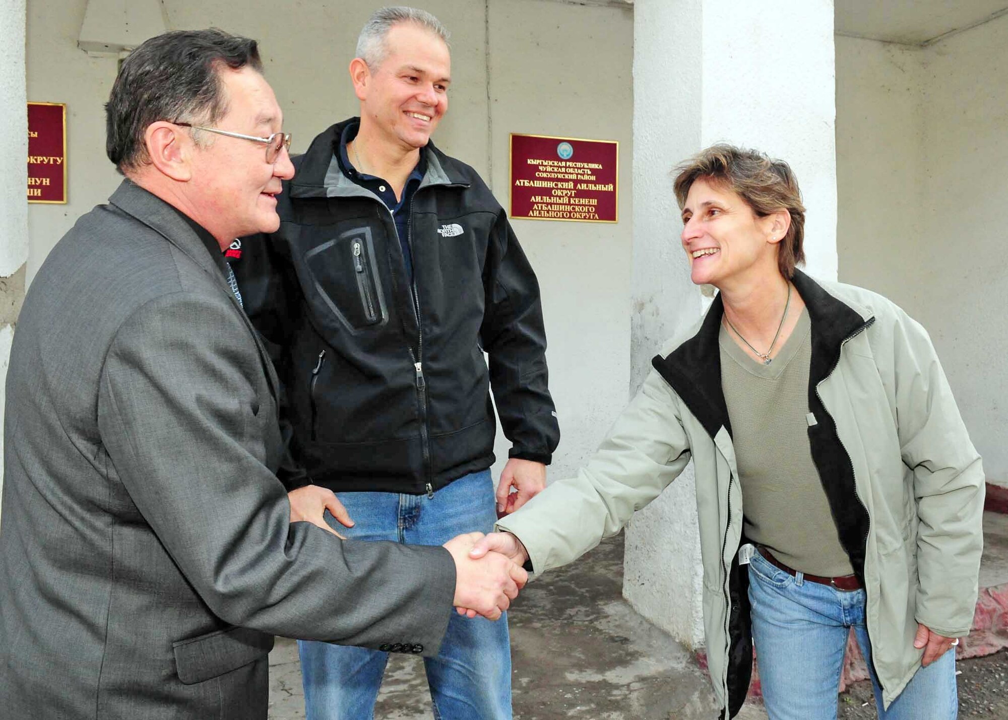 Chief Master Sgt. Debra Liles shakes the hand of the mayor of Manas Village, March 18, 2010, in Manas Village, Kyrgyzstan. Chief Liles is the 376th Expeditionary Mission Support Group superintendent. (U.S. Air Force photo/Staff Sgt. Carolyn Viss)