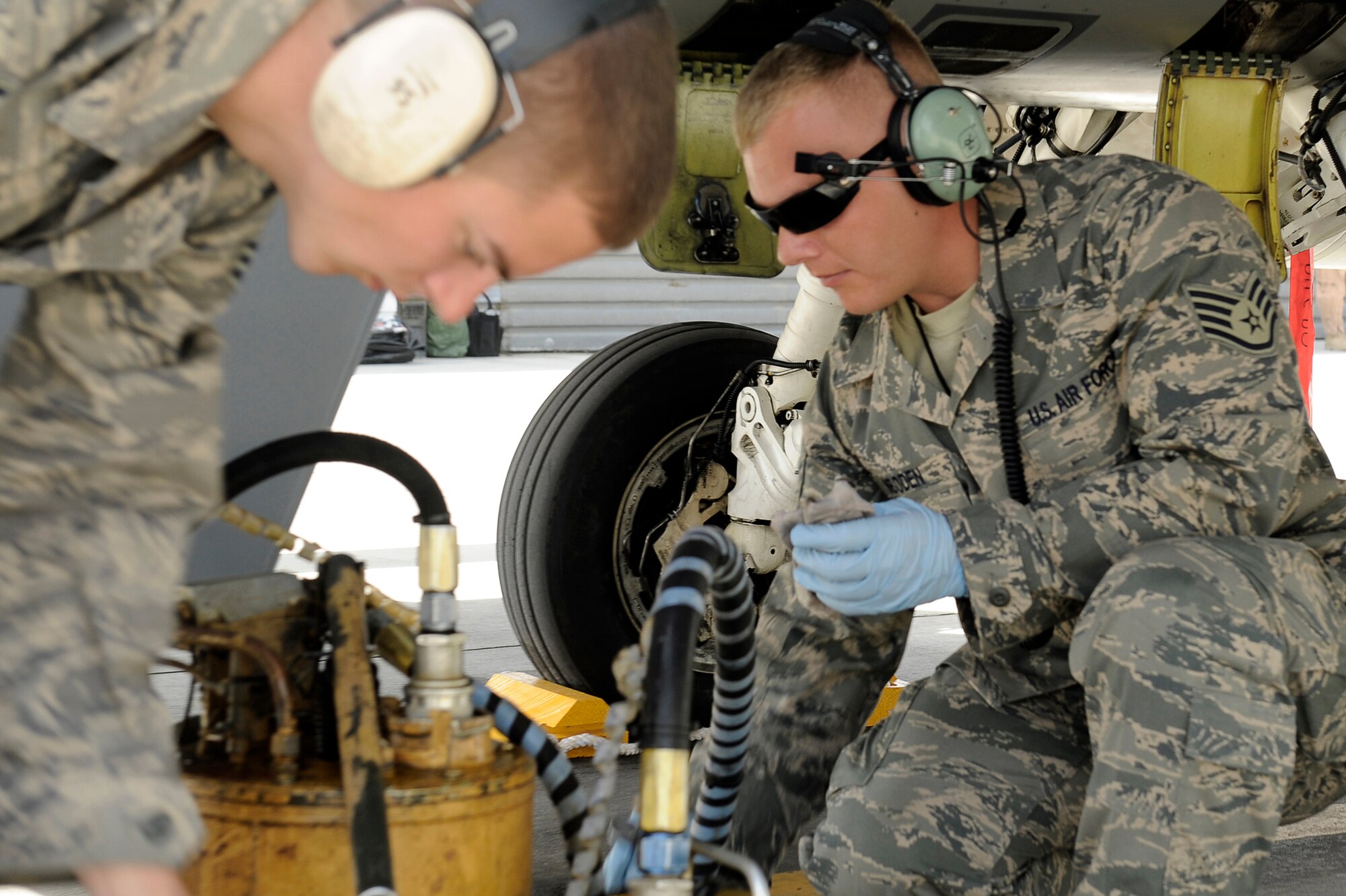 Senior Airman Anthony Creasey (left) and Staff Sgt. Lucas Inboden, maintainers from the 34th Expeditionary Fighter Squadron at Bagram Airfield, Afghanistan, recover an F-16 Fighting Falcon March 23, 2010, after it completed its 30th code 1 flight, meaning no maintenance write-ups for 30 flights in a row.  The Airmen are deployed from Hill Air Force Base, Utah.  (U.S. Air Force photo/Tech. Sgt. Jeromy K. Cross)