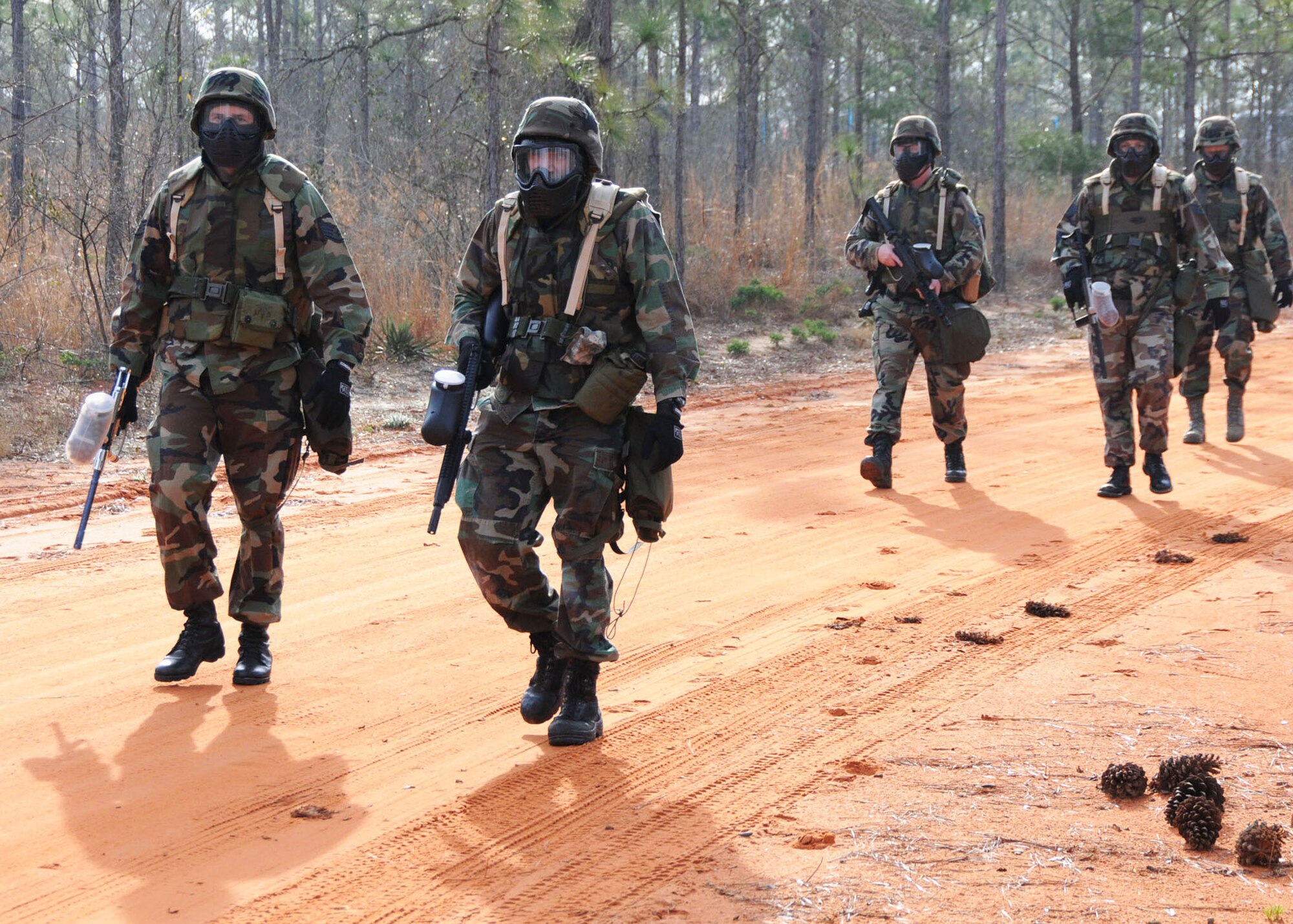 Outfitted with paintball gear for a simulated combat scenario, members of the Tennessee Air National Guard’s 119th Command and Control Squadron head to the first of several checkpoints on a combat readiness training course at Duke Field March 24.  More than 150 of the squadron’s members traveled to Duke Field for a week-long field training exercise that fulfilled their annual training requirements. (U.S. Air Force photo/Staff Sgt. Jon McCallum)
