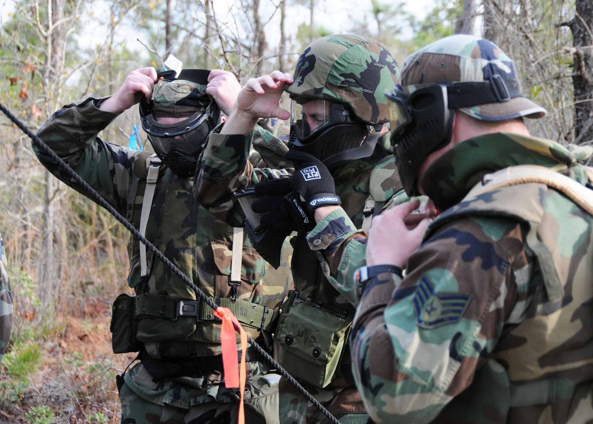 Donning paintball gear for a simulated combat scenario, members of the Tennessee Air National Guard’s 119th Command and Control Squadron prepare for the first of several checkpoints on a combat readiness training course at Duke Field March 24.  More than 150 of the squadron’s members traveled to Duke Field for a week-long field training exercise that fulfilled their annual training requirements. (U.S. Air Force photo/Staff Sgt. Jon McCallum)