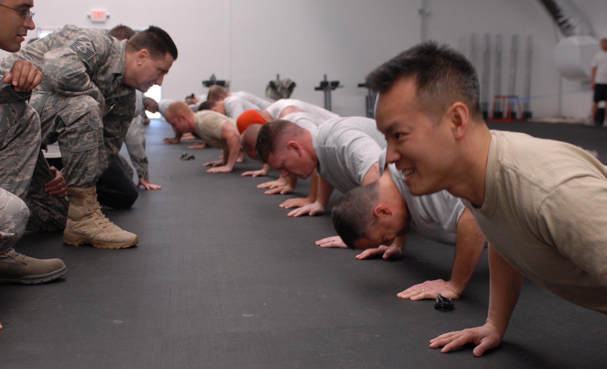 Maj. Auy Nguyen, 56th Comptroller Squadron commander, does push-ups March 11 during the fund raiser. Maj. Nguyen performed 121 push-ups. (Photo by Airman 1st Class Sandra Welch)