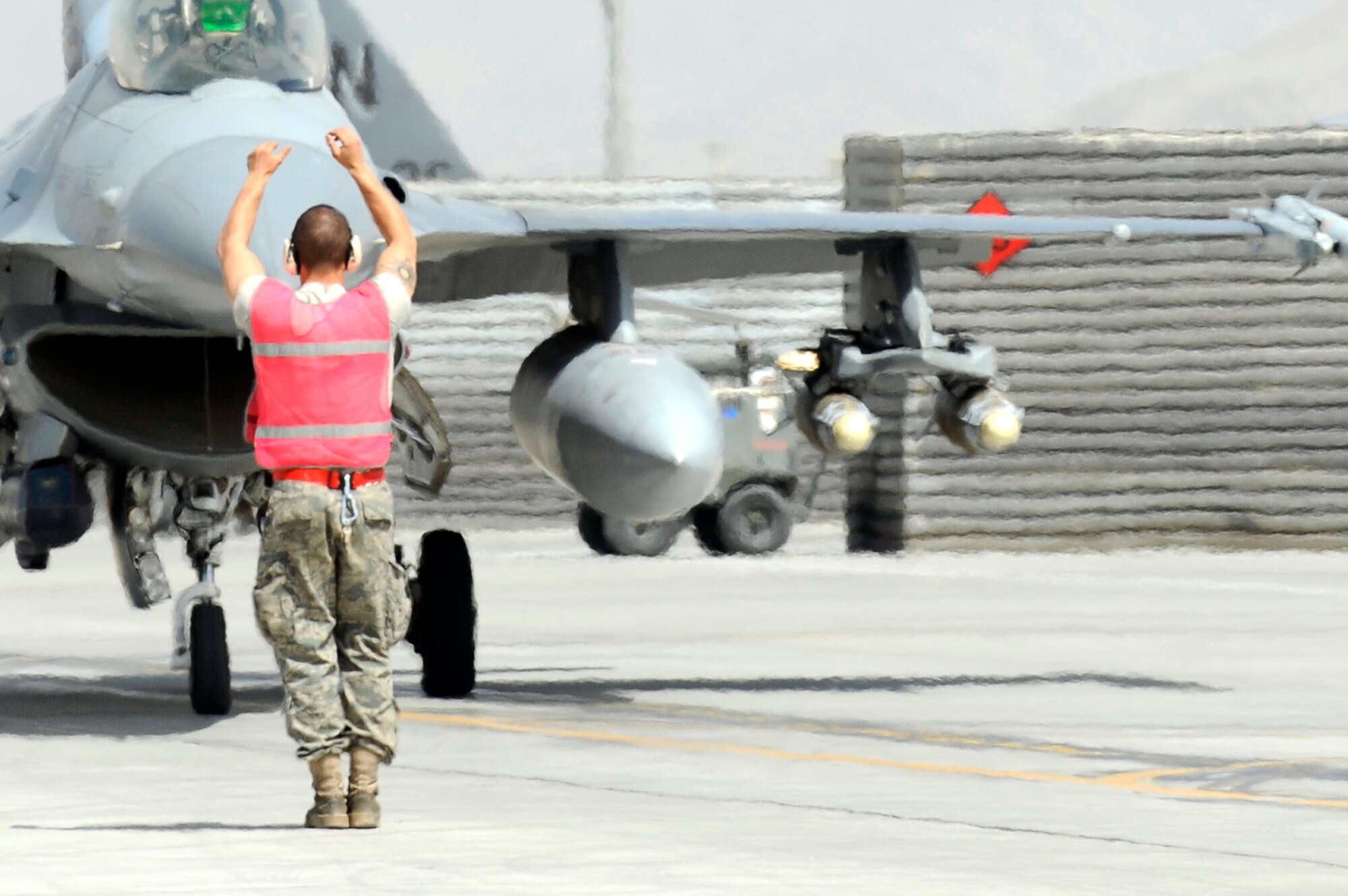 Staff Sgt. Lucas Inboden, a crew chief from the 34th Expeditionary Fighter Squadron at Bagram Airfield, Afghanistan, recovers this F-16 Fighting Falcon March 23, 2010, after it completed its 30th code 1 flight, meaning no maintenance write-ups for 30 flights in a row.  Sergeant Inboden is deployed from Hill Air Force Base, Utah.  (U.S. Air Force photo/Tech. Sgt. Jeromy K. Cross)