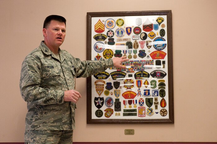 NELLIS AIR FORCE BASE, NEV.-- Colonel Gregory Allen, 99th Medical Group deputy commander, discusses a collage which was presented to the Mike O' Callahan Federal Hospital in order to recognize all veterans and active duty servicemembers of the United States military. Patches, the group who donated the collage, creates collages for military members, children's hospitals and other organizations. All of the work done by Patches is made possible through donations, which usually come from veterans and their families. 
(U.S. Air Force Photo / Airman 1st Class Jamie Nicley)