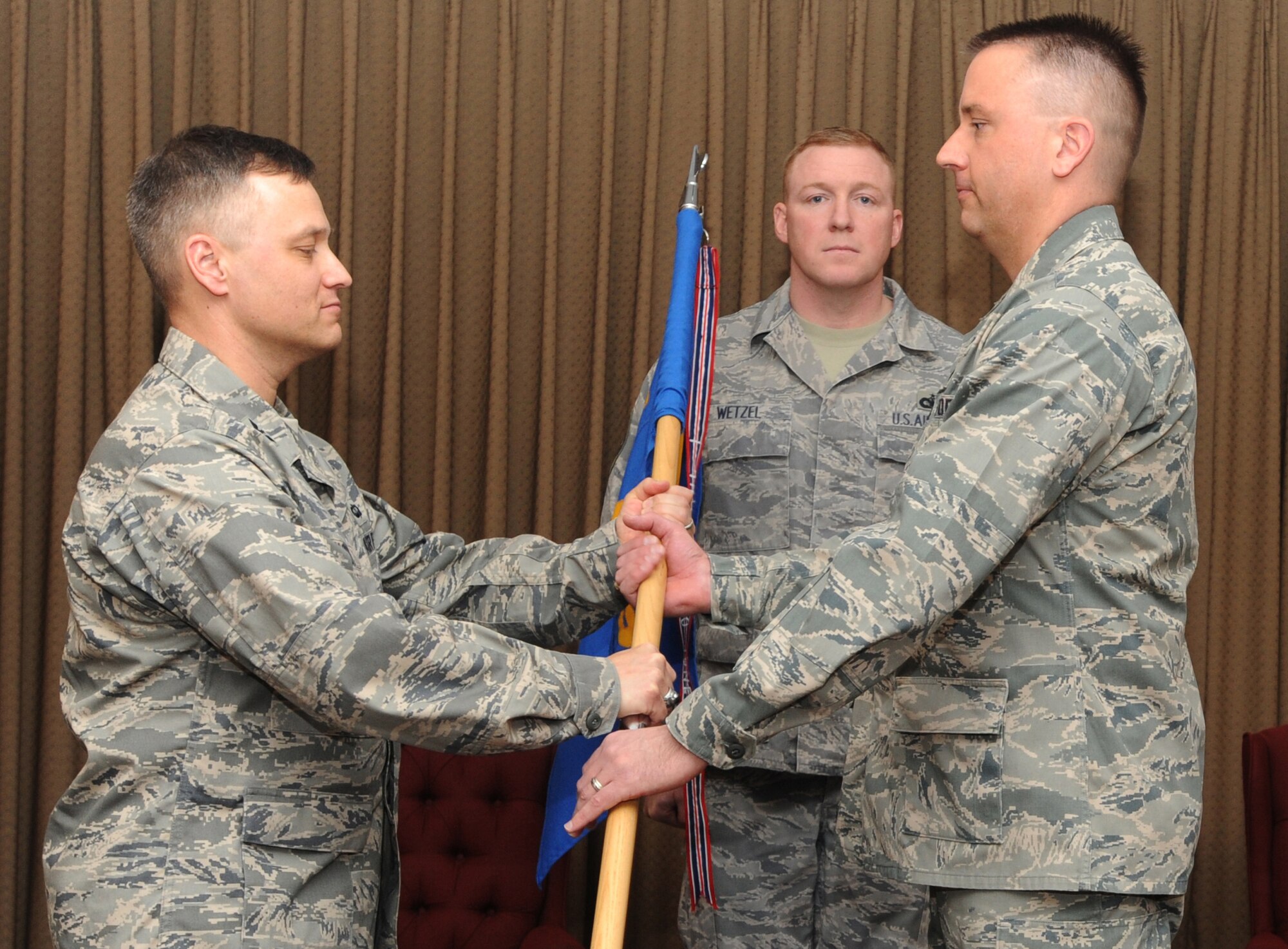 Lt. Col. Darin C. Driggers assumes command of the 319th Operation
Support Group from Col. Henry W. Polczer, 319th Operations Group commander
during a change-of-command ceremony March 26 at the Northern Lights Club.
Colonel Driggers is replacing Lt. Col. James L. Warnke.
