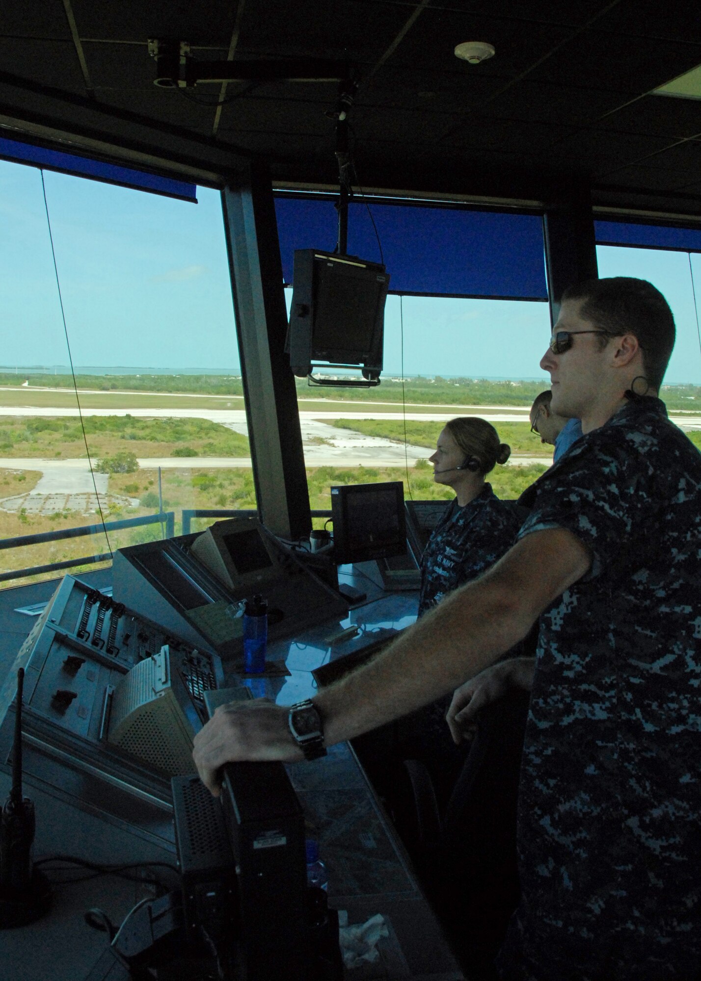 Petty Officer 2nd Class Andrew Hanson and Petty Officer 2nd Class Emmily Trolinger, both Navy air traffic control specialists from the Navy Air Station Key West, Fla., direct sky traffic March 24, 2010, including directing F-16C Flying Falcons from the 115th Fighter Wing in Madison, Wis., as the 115th FW takes part in a two week air-to-air combat skills training mission at NAS.   Close to 145 Airmen of the 115th FW gained valuable training as their F-16 Falcons sparred against Navy F-18 Super Hornets and F-5 Tigers here.  (U.S. Air Force photo by Airman 1st Class Ryan Roth, 115 FW/PA)