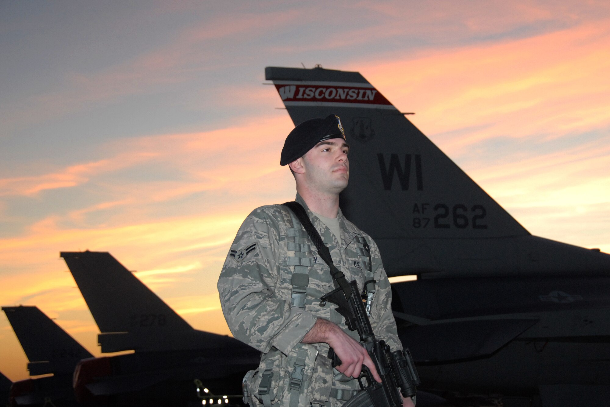 Airman 1st Class Justin Padley, a member of the 115th Fighter Wing security forces, stands guard March 23, 2010, at Naval Air Station Key West, keeping a watchful eye on F-16C Fighting Falcons as he and close to 145 Airmen of the 115th FW in Madison, Wis., spent approximately two weeks at NAS gaining valuable training as their F-16 Flying Falcons sparred against Navy F-18 Super Hornets and F-5 Tigers here.  (U.S. Air Force photo by Airman 1st Class Ryan Roth, 115 FW/PA)