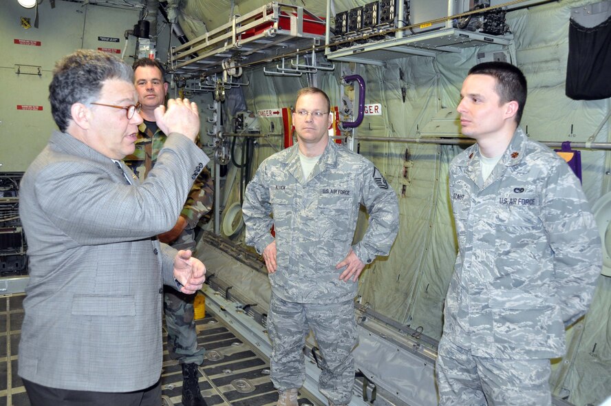Senator Al Franken talks with (from left) Master Sgts. Stephen Hutchinson, Conrad Kluck and Maj. Andrew Staut, March 21. The senator received a mission briefing and toured the base during his visit. (Air Force Photo/Master Sgt. Paul Zadach)