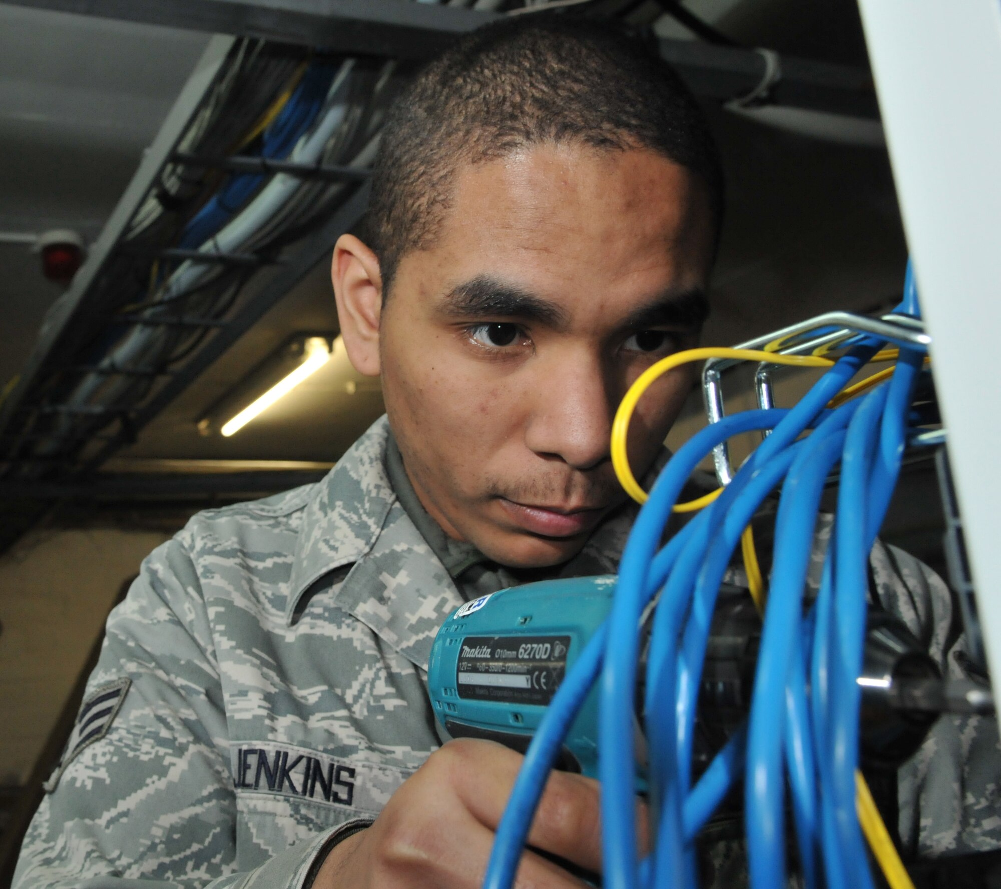 SPANGDAHLEM AIR BASE, Germany – Senior Airman Aaron L. Jenkins, 52nd Communications Squadron cable and antenna systems journeyman, installs local area network cables to a 24-port patch panel March 22. Airman Jenkins is the 52nd Fighter Wing's Top Saber Performer for the week of Mar.26-Apr. 1. (U.S. Air Force photo/Airman 1st Class Nick Wilson)