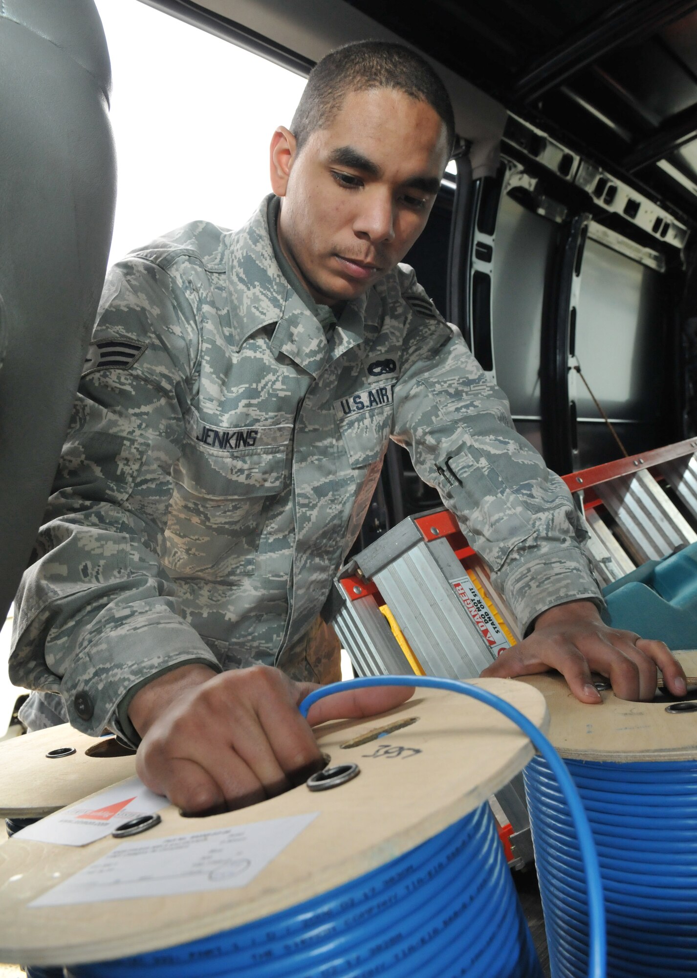 SPANGDAHLEM AIR BASE, Germany– Senior Airman Aaron L. Jenkins, 52nd Communications Squadron cable and antenna systems journeyman, gathers equipment and material to install new local area network drops and terminals for an installation control center March 22. Airman Jenkins is the 52nd Fighter Wing's Top Saber Performer for the week of Mar.26-Apr. 1. (U.S. Air Force photo/Airman 1st Class Nick Wilson)