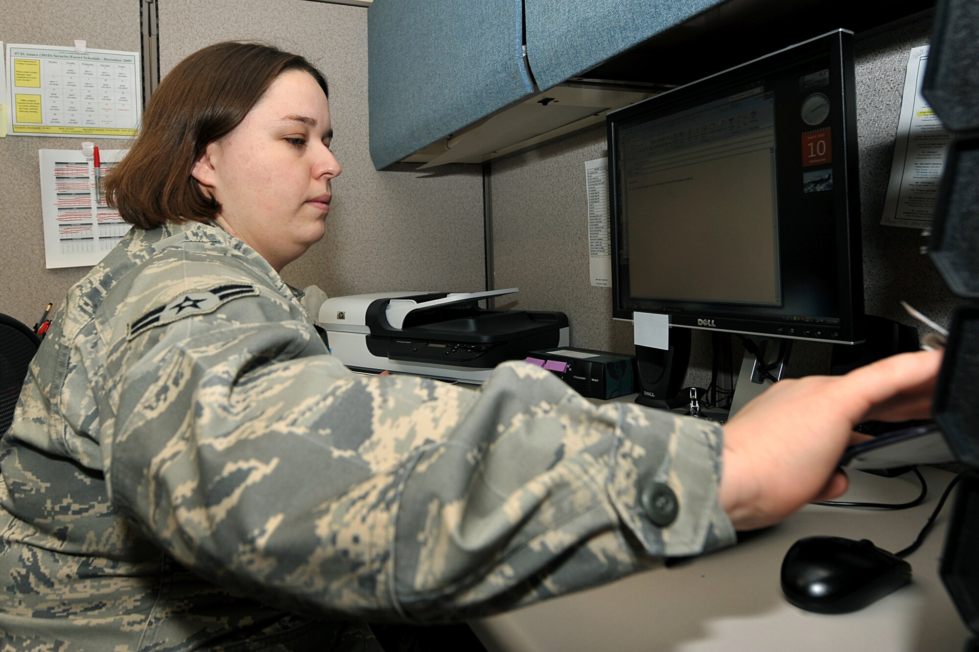 OFFUTT AIR FORCE BASE, Neb. -- Airman 1st Class Jennifer Jalbert, a cryptologic operator with the 97th Intelligence Squadron, files an Airman's training records inside the Martin Bomber Building here Mar. 10. Airman Jalbert volunteers on a regular basis and was one of the 97th IS's points of contact for the Air Force Assistance Fund and Combined Federal Campaign, as well as base blood drives. U.S. Air Force photo by Charles Haymond