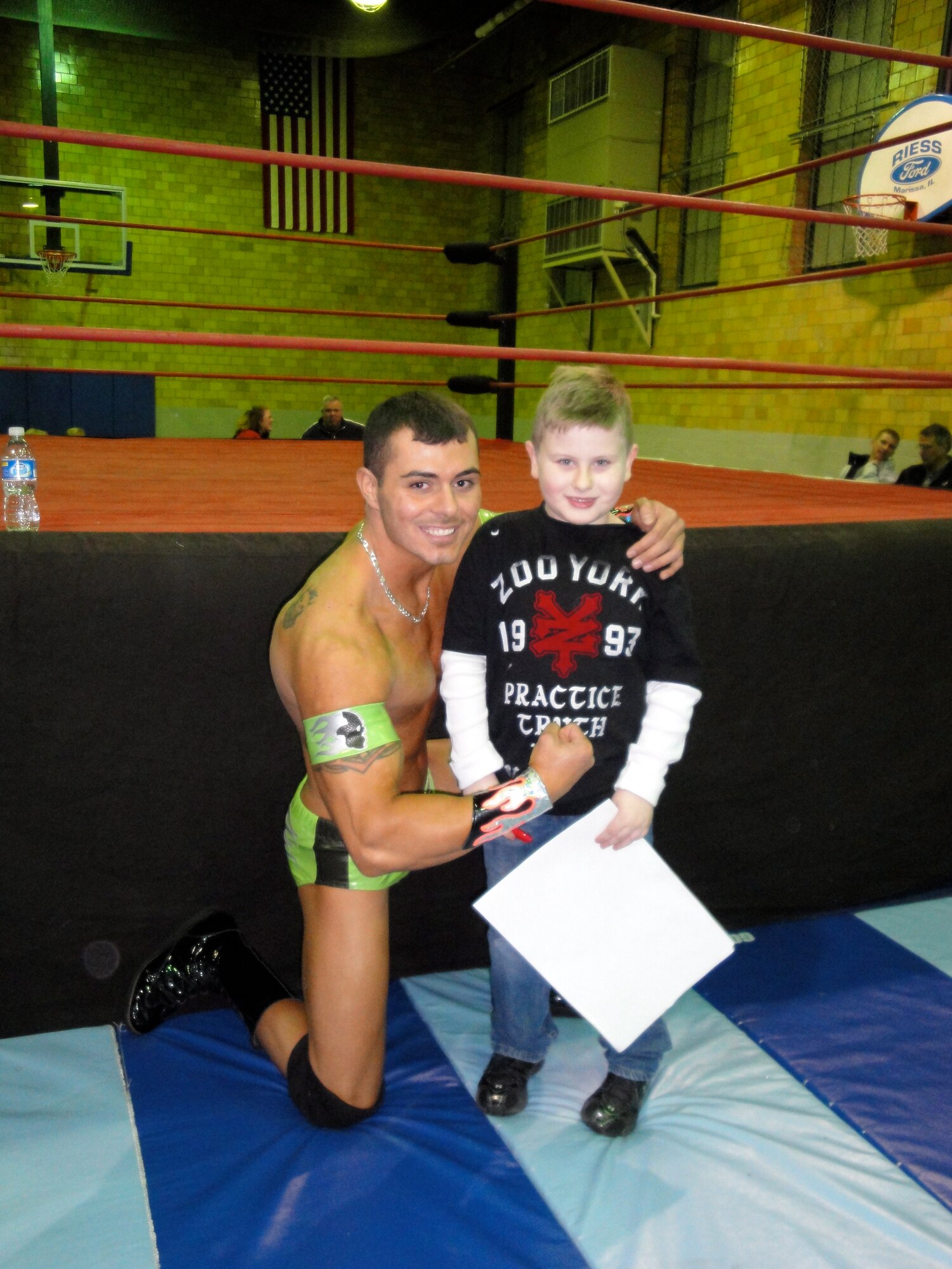 SCOTT AIR FORCE BASE, Ill. -- Staff Sgt. Timothy "Shane the Serial Thriller" Rich, poses for a photo with a young fan after a match at the Leu Civic Center in Mascoutah, Ill. (courtesy photo)