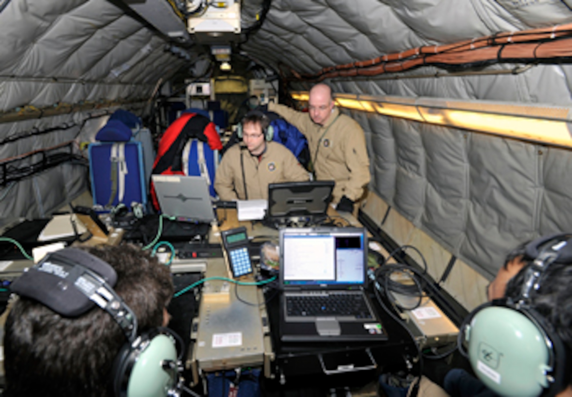 MIT Lincoln Laboratory engineers Chayil Timmerman (left) and John Murphy conduct an airborne test in March as part of the High Data Rate Airborne Terminal Program.  The team used a 707 test bed aircraft to test out the transmission capabilities of a prototype waveform developed as part of the program. (Courtesy photo)