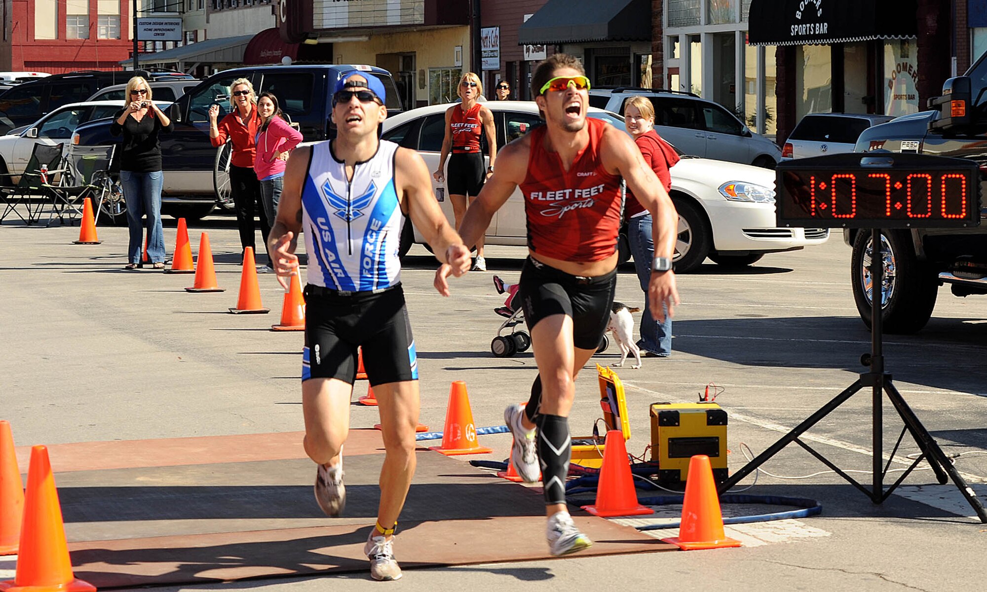 John Dalrymple, left, crosses the finish line at the Fall Classic Duathlon in Purcell just half a second before the second-place finisher. The air battle manager with the 963rd Airborne Air Control Squadron is currently training to compete in the Route 66 Triathlon in El Reno in June. (Courtesy photo)