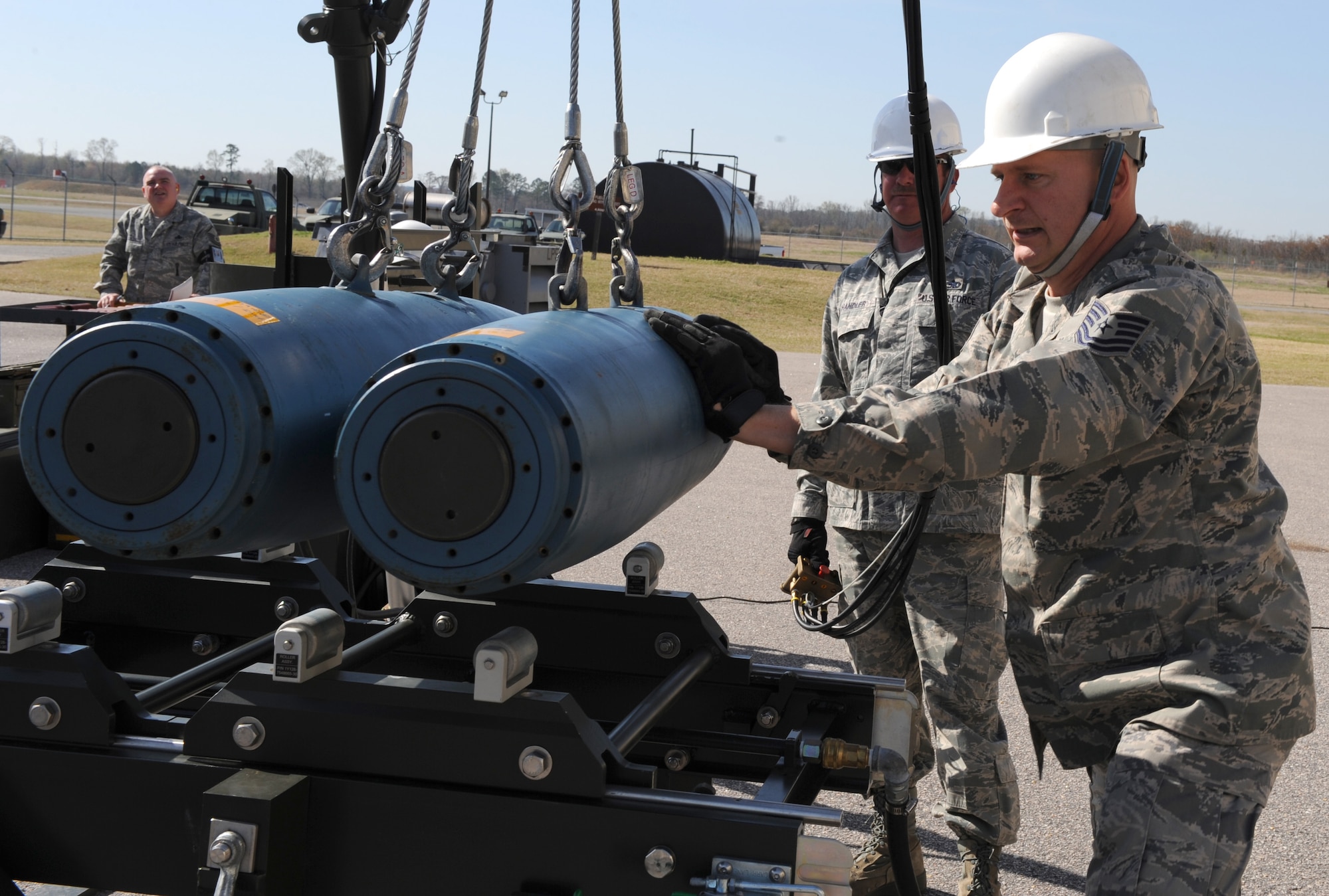 Tech. Sgts. Kevin Tolliver and Robert Chandler, both 4th Equipment Maintenance Squadron conventional maintenance technicians, load GBU-38 training bombs onto a rack on Seymour Johnson Air Force Base, N.C., March 24, 2010. The 4th EMS Airmen are building training bombs in preparation for the upcoming Phase I Operational Readiness Exercise. Tolliver hails from Beckley, W. Va. and Chandler is a native of Charlotte, N.C. (U.S. Air Force photo/Airman 1st Class Gino Reyes)