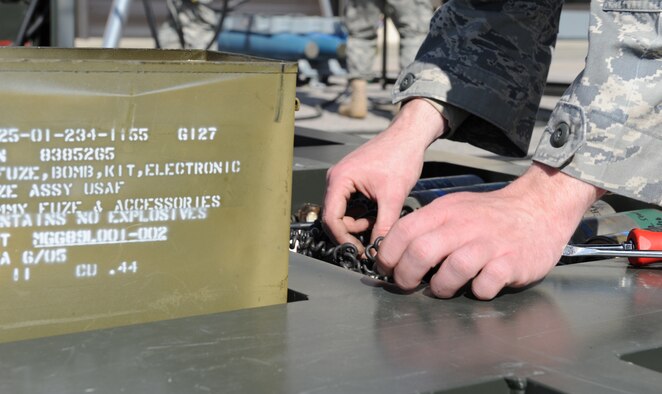 Senior Airman Zachary Jones, 4th Equipment Maintenance Squadron conventional maintenance technician, connects wire to a bomb fuse during a GBU-38 bomb build on Seymour Johnson Air Force Base, N.C., March 24, 2010. 4th EMS Airmen build approximately 28 GBU-38 training bombs during a bomb build. Sergeant Jones hails from Chickamauga, Ga. (U.S. Air Force photo/Airman 1st Class Gino Reyes)